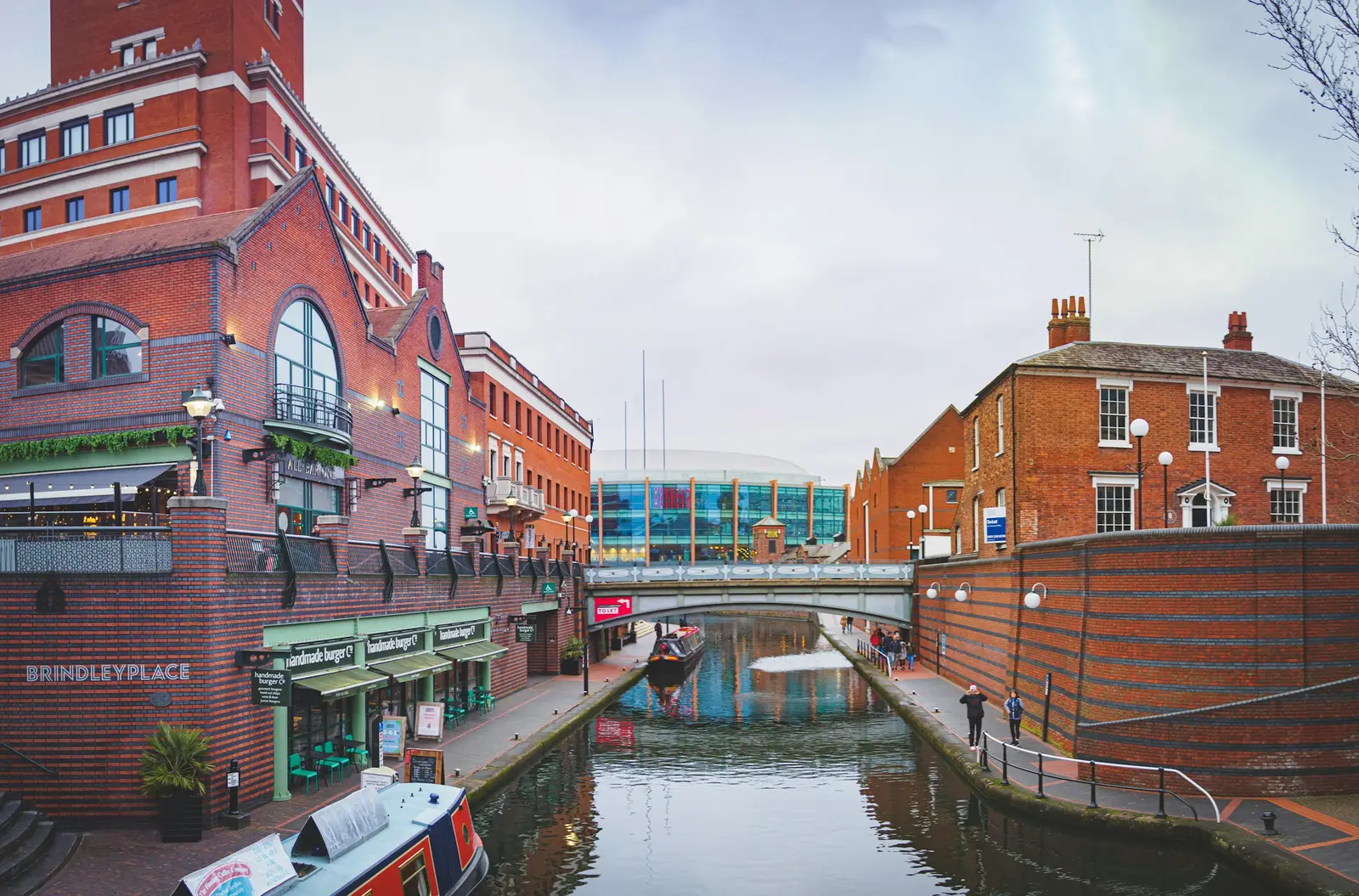 Narrowboats moored at Gas Street Basin in Birmingham, with brick canal buildings behind