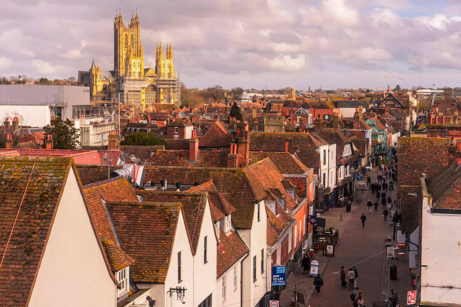 Timber-framed buildings over the River Stour in Canterbury with the cathedral tower beyond