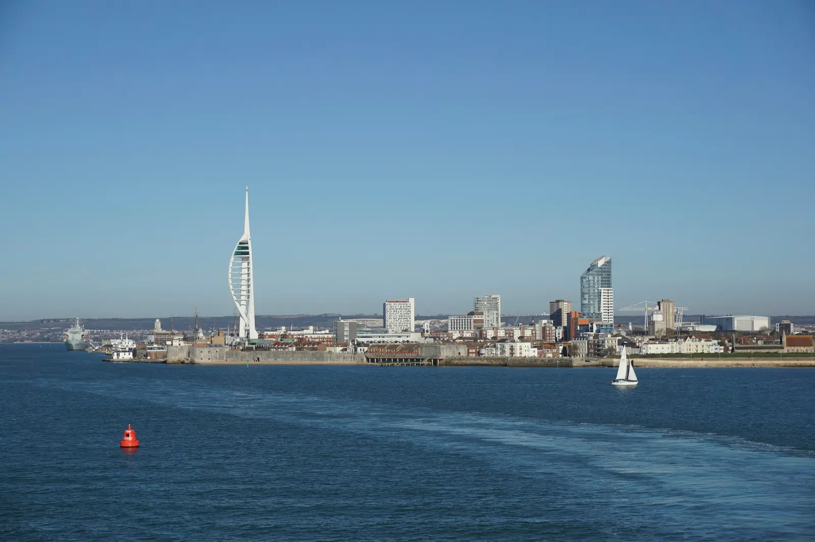 Couple on the Round Tower in Old Portsmouth with a ferry passing and the Spinnaker Tower behind