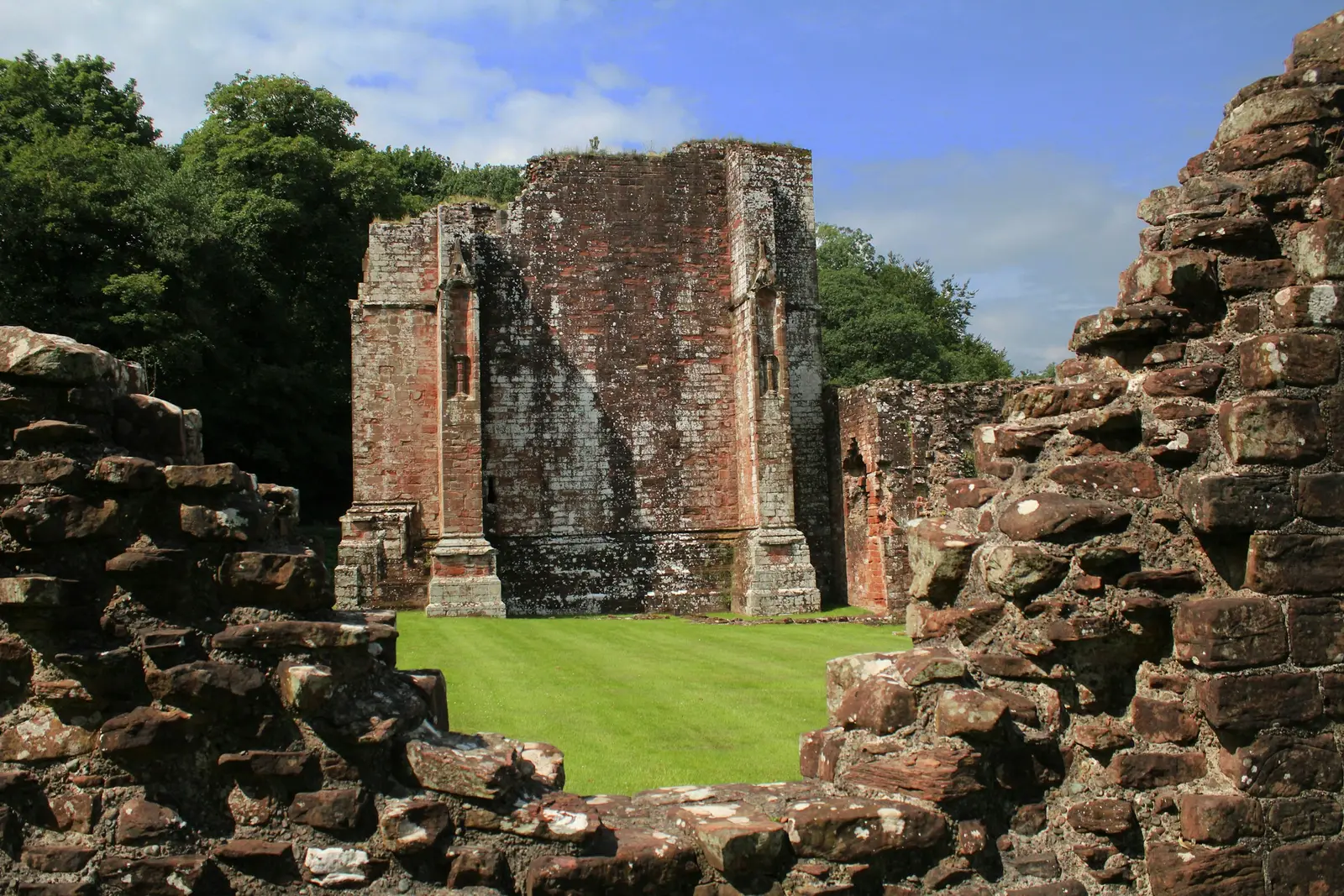 Professional headshot taken beside the flint walls of Reading Abbey ruins