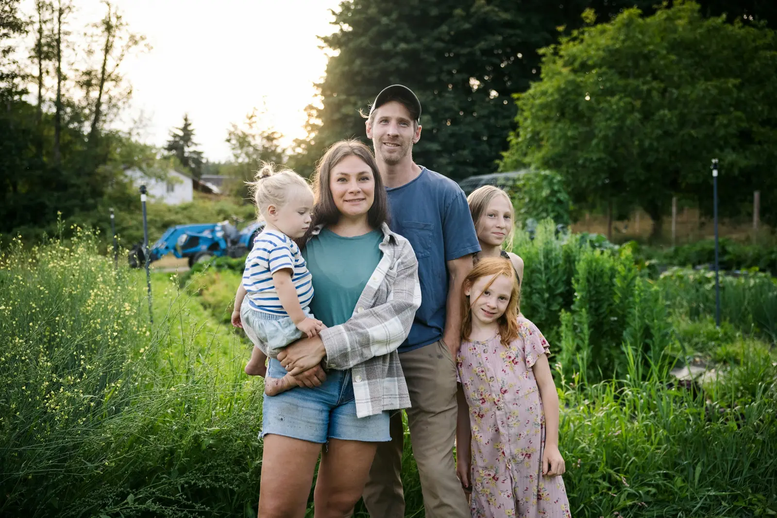 A photographer showing a family some images on the back of the camera during an outdoor session