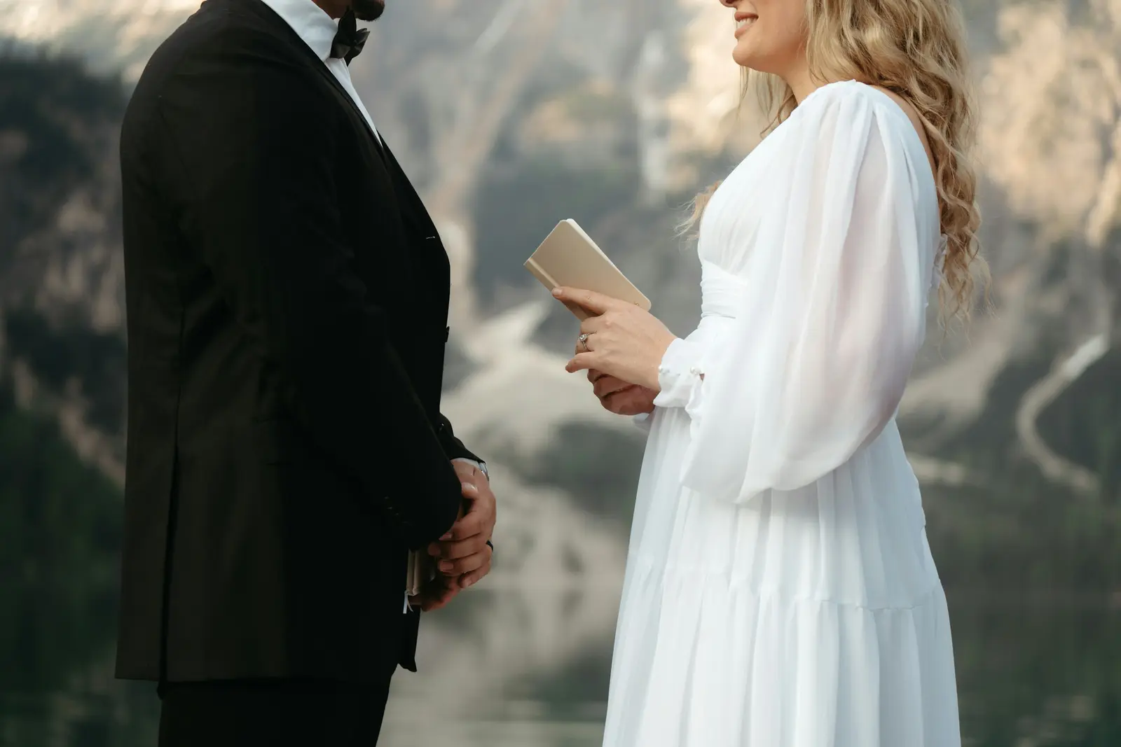 A couple looking through a full gallery of photographs on a laptop while choosing a photographer